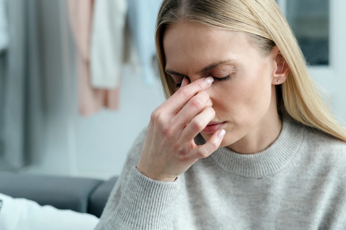 Woman rubbing dry eyes
